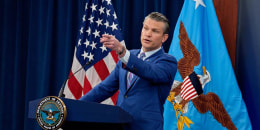 Defense Secretary Pete Hegseth, accompanied by Chairman of the Joint Chiefs of Staff Air Force Gen. Dan Caine takes a question from a reporter during a news conference at the Pentagon