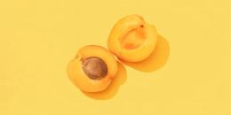 Apricots on a yellow background.