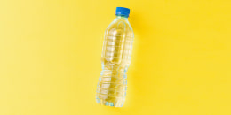 Overhead shot of water bottle on a yellow background.