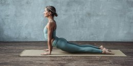 Woman doing upward dog yoga.