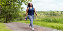 Woman on an exercise walk through a public park.