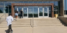 People enter the Arapahoe County Justice Center in Centennial, Colo., on July 14, 2025.