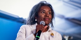 Winsome Earle-Sears holds a microphone on stage
