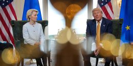 From left, Ursula von der Leyen, and Donald Trump sit inside of a room
