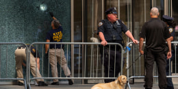 Members of the NYPD Crime Unit examine a door with bullet holes at the scene of the previous day's deadly shooting, Tuesday, July 29, 2025, in New York.