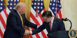 President Donald Trump and House Speaker Mike Johnson shake hands at a reception at the White House 