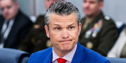 Pete Hegseth looks on during a meeting.
