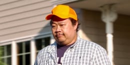 Xp Lee walks outside near a house
