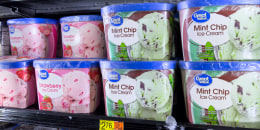 A view of rows of mint chip and strawberry ice cream containers in a store freezer