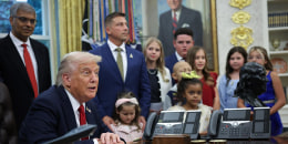 President Donald Trump is joined by childhood cancer survivors and their families in the Oval Office on Sept. 30, 2025.