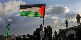 Armed Palestinians stand guard at the site where Hamas handed over the bodies of four Israeli hostages to the Red Cross in Khan Yunis, Gaza, on Feb. 20, 2025. 