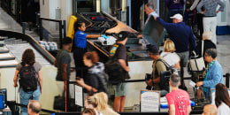 Travelers at a security checkpoint at 