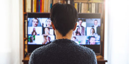Woman in front of a device screen in video conference for work.
