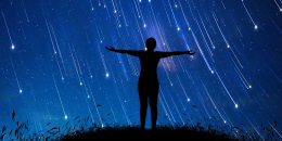 A girl standing in the midst of The stars at night with a meteor full of sky, concepts, imaginations, dreams