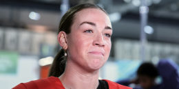 Taylor Heise stands in front of a reporter's microphone while wearing a red hockey uniform. 