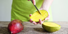 Hand Holding Fresh Mango