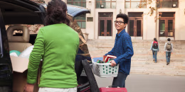Young man moving into dormitory on college campus