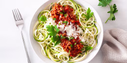 keto paleo zoodles bolognese: zucchini noodles with meat sauce and parmesan