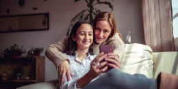 Mother and daughter using a smartphone
