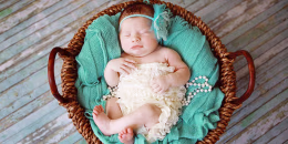 Newborn Baby Girl Sleeping in a Basket