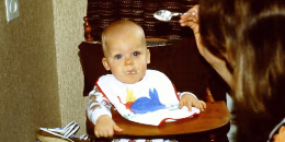 Young mother feeding her baby boy c. 1980's.