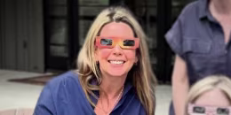 Suzanne Simpson wearing eclipse glasses.