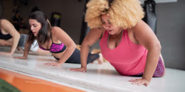Group of women doing push ups exercise class at the gym