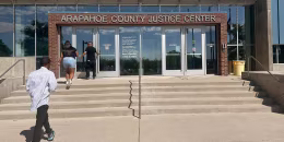 People enter the Arapahoe County Justice Center in Centennial, Colo., on July 14, 2025.