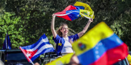 People wave Venezuelan flags outside