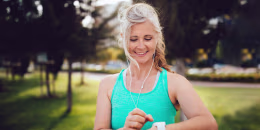 Athletic mature woman monitoring her running performance on smartwatch