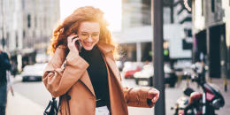Woman walking and talking on the phone to improve mental health