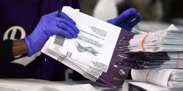 Canvassers open and review mail-in and absentee ballots for the 2024 General Election at the Baltimore City Board of Elections.