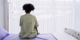 Lonely patient sitting on the hospital bed