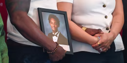 Nolan Wells photo frame is being held by his mother and step father.