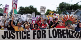 A crowd of protestors standing behind a banner reading JUSTICE FOR LORENZO! ICE OUT OF HOUSTON
