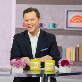 Willie Geist sitting at the desk with a yellow Sunday TODAY mug