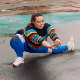 Young Woman Stretching on Basketball Court