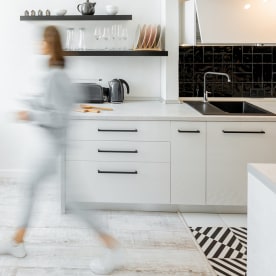 Kitchen with blurred human figure