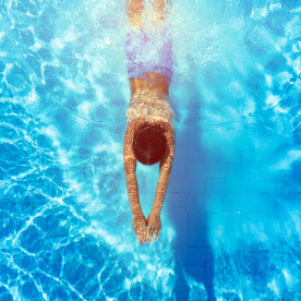 boy diving in the swimming pool
