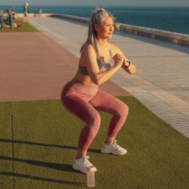 Healthy adult female exercising by the waterfront