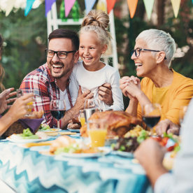 family playing games around table with Thanksgiving decor