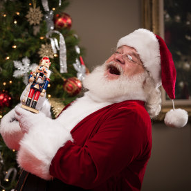 Real Santa Laughing While Putting Goodies in Stockings