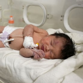 A newborn baby receives medical care on Feb. 7, 2023, after being rescued from the rubble of a home in northern Syria.