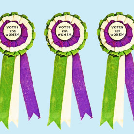 votes for women ribbons on blue background