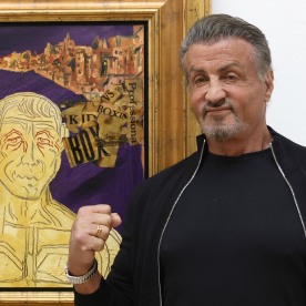 Sylvester Stallone stands next to a painting during the opening of the exhibition "Sylvester Stallone - Retrospektive zum 75. Geburtstag" at Osthaus Museum Hagen on December 03, 2021 in Hagen, Germany.