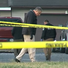 Investigators at the scene of a shooting where three people were killed, two of them children
