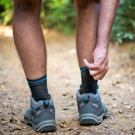 Close up of the itchy legs of a hiker walking through the woods.