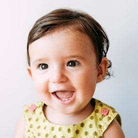 Portrait of happy baby girl wearing a dress