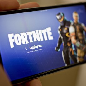 The Epic Games Inc. Fortnite: Battle Royale video game is displayed an iPhone.