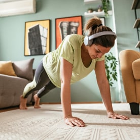 Adult woman exercising at home doing push ups
